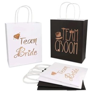 Detail of Team Bride and Team Groom gift bags with rose gold foil for wedding party guests
