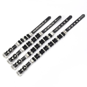 Detailed view of four pearl pet collars with black leather straps in S to XL sizes