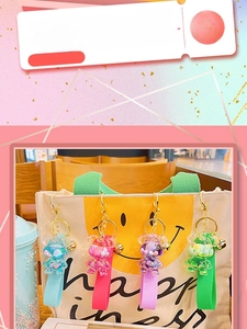 Close-up of colorful liquid floating bear keychains with glitter on a canvas bag