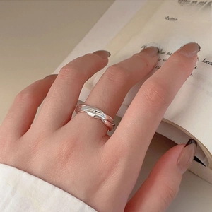 Minimalist 925 sterling silver ring with twisted diagonal pattern on a vintage book