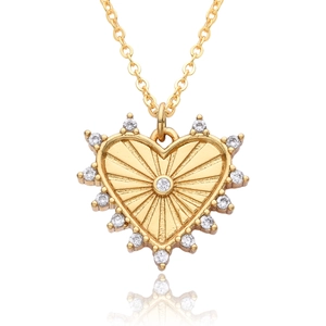 Macro view of 18k gold plated heart pendant necklace with radiant texture and zircons