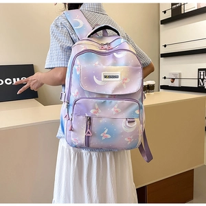 Rear view of a purple gradient school backpack with butterfly prints worn by a model
