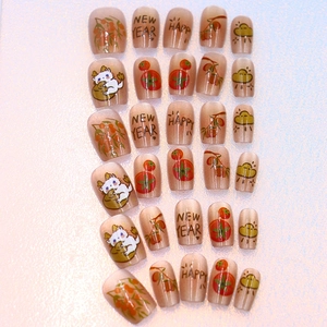 Cat eye press-on nails with cute dragon and persimmon motifs for New Year celebration