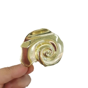 Golden sea shell hair claw clip with metallic spiral texture for beach vacation