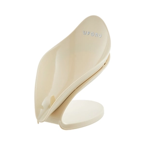 Leaf-shaped self-draining soap holder in off-white finish with sturdy drainage base