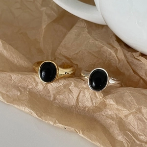 Macro detail of retro S925 sterling silver rings with oval black onyx gemstone