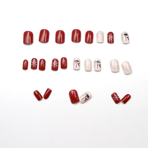 Christmas press-on nail set featuring red gloss, white glitter, and cute snowman designs