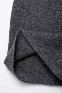 Close-up of grey knit dress fabric texture showing soft wool-like fibers and weave