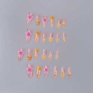 Detailed view of almond press-on nails featuring 3D flowers, pearls and golden wavy lines