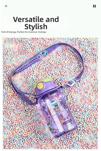 Detail of purple cartoon kids water bottle with straw, adjustable strap and robot patterns