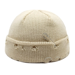 Hip-hop cream docker hat with knitted distress holes, silver rings, and pin detail