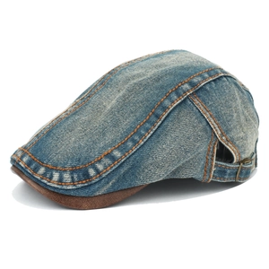 Close-up of washed denim ivy cap with orange stitching and brown suede brim