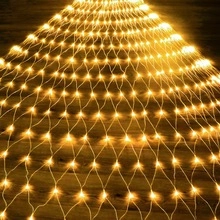 Close-up of warm yellow LED net lights on dark wood, creating a cozy star atmosphere