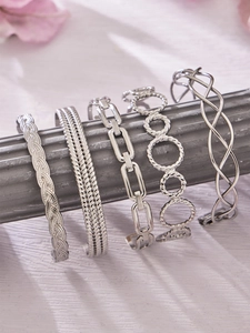 Detailed display of silver stainless steel bracelets with assorted textures and trendy motifs