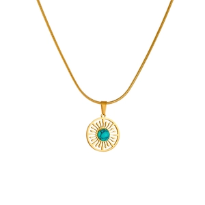 Gold plated stainless steel necklace featuring a turquoise sunburst pendant on white background