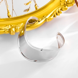 Polished silver wide cuff bangle in stainless steel with a minimalist wavy design
