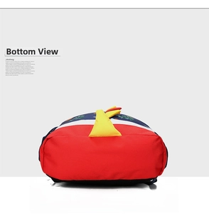 Detail view showing red oxford fabric bottom and yellow dinosaur spikes of the kids backpack