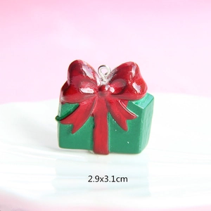 Macro shot of a red and green Christmas gift box charm with a silver clasp, size 2.9x3.1cm