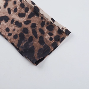 Detailed close-up of leopard print bodysuit fabric with high-quality stitching detail