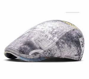 Detail view of cotton newsboy cap featuring black and yellow tie-dye graffiti patterns