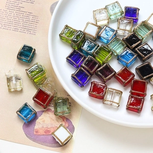 Close-up of colorful vintage cube beads with gold edges for DIY jewelry making