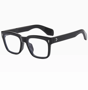 Detail of black square sunglasses with metallic diamond studs and star accents