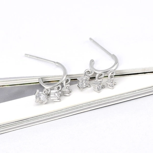 Detail of s925 silver stud earrings with three prong-set cubic zirconia and tassels
