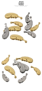 Macro view of detailed vintage feather charms in polished gold and silver stainless steel