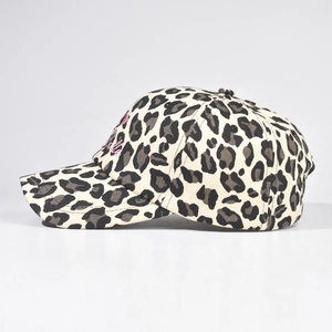 Leopard print baseball cap with pink embroidery detail in a side profile studio shot