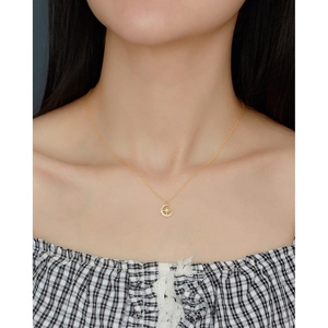 Close-up of a gold-plated S925 star and moon pendant necklace worn by a model