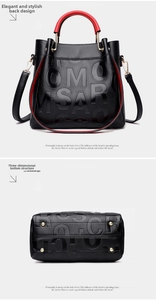 Detail view of embossed lychee leather tote with red handle lining and metal base studs