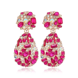 Vintage oversized gold alloy teardrop earrings with pink and clear crystals on white background