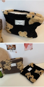 Close-up of teddy bear pattern canvas cosmetic bag with zipper and textile label