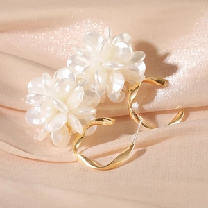 Elegant 3D cream floral hoop earrings with golden twisted metal on champagne satin