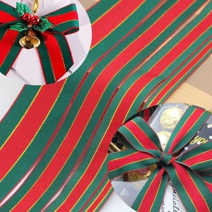 Festive red and green striped Christmas ribbon with gold edges for gift wrapping