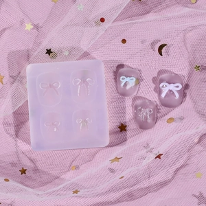 Detail of 4-cavity bow silicone nail art mold showing clear texture and finished 3D resin bows