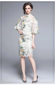 Detail of silver-white cheongsam dress featuring colorful floral lace and trumpet sleeves