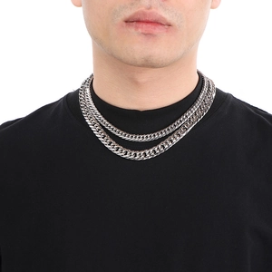 Polished silver stainless steel Cuban link chain necklace shown on a male model
