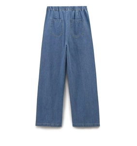 Detail of blue wide-leg denim trousers showing elastic waistband and back pockets