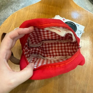 Internal view of red canvas storage bag with red plaid lining and inner pocket