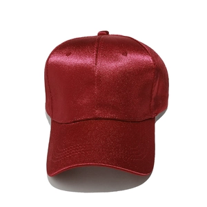 Detailed close-up of vibrant red sequin fabric texture on a classic baseball cap