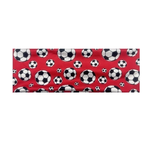Close-up of a red elastic sports headband with black and white football patterns
