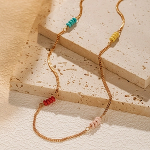 18K gold plated chain necklace featuring colorful turquoise beads on natural stone background