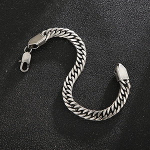 Detailed view of heavy stainless steel Cuban chain with lobster clasp on black background