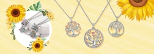 Detail view of silver cat pendants and tree of life necklaces with colorful crystals