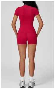 Rear view of red short-sleeve slim fit yoga top and high-stretch mini sports shorts