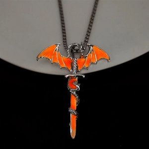 Close-up of silver dragon and sword pendant with glowing orange wing detail