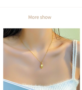 Close-up of golden leaf pendant necklace with realistic texture on a model's collarbone