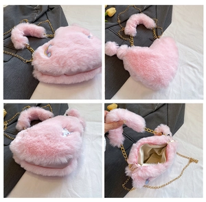 Detailed close-up of pink heart plush crossbody bag with bunny embroidery and gold chain