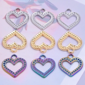 Macro shot of heart-shaped stainless steel charms in silver, gold and rainbow finishes